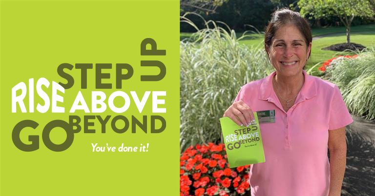 Atria Senior Living employee smiling after winning the Above and Beyond award.