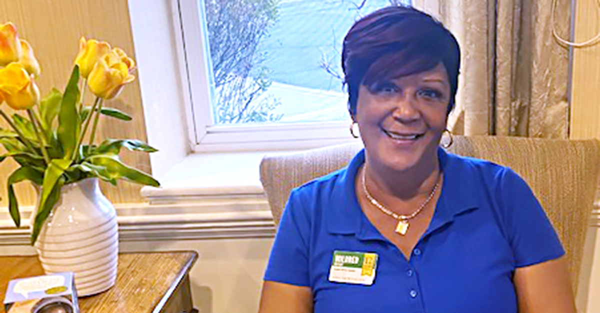 Mildred, an Atria Senior Living employee smiling at work.